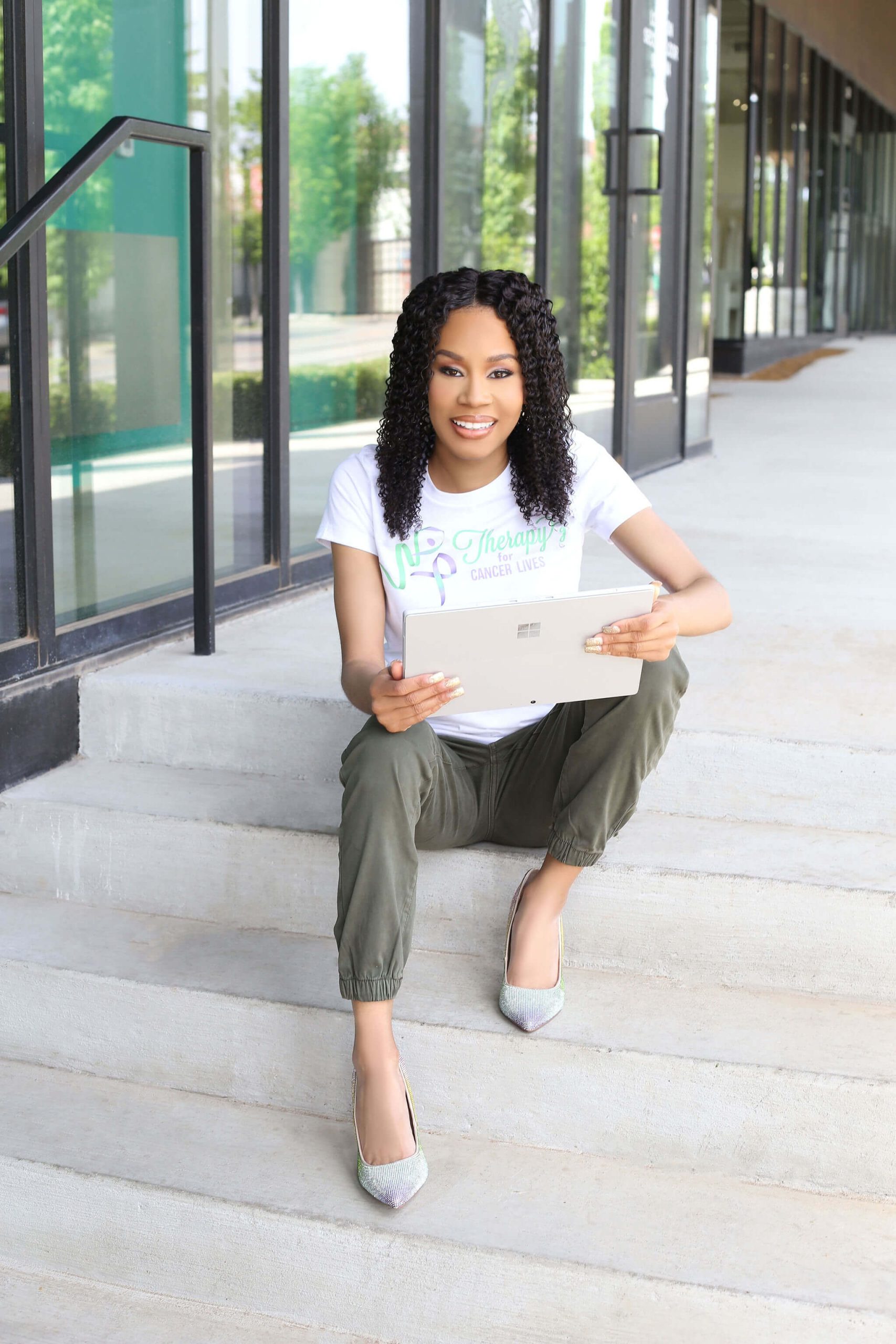 logo sitting on steps with laptop